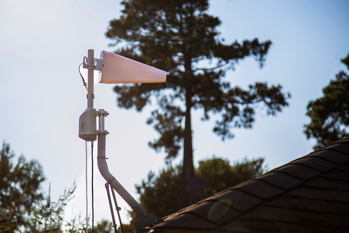 A SOCA rotator carrying a log periodic antenna on a roof mast at a house.